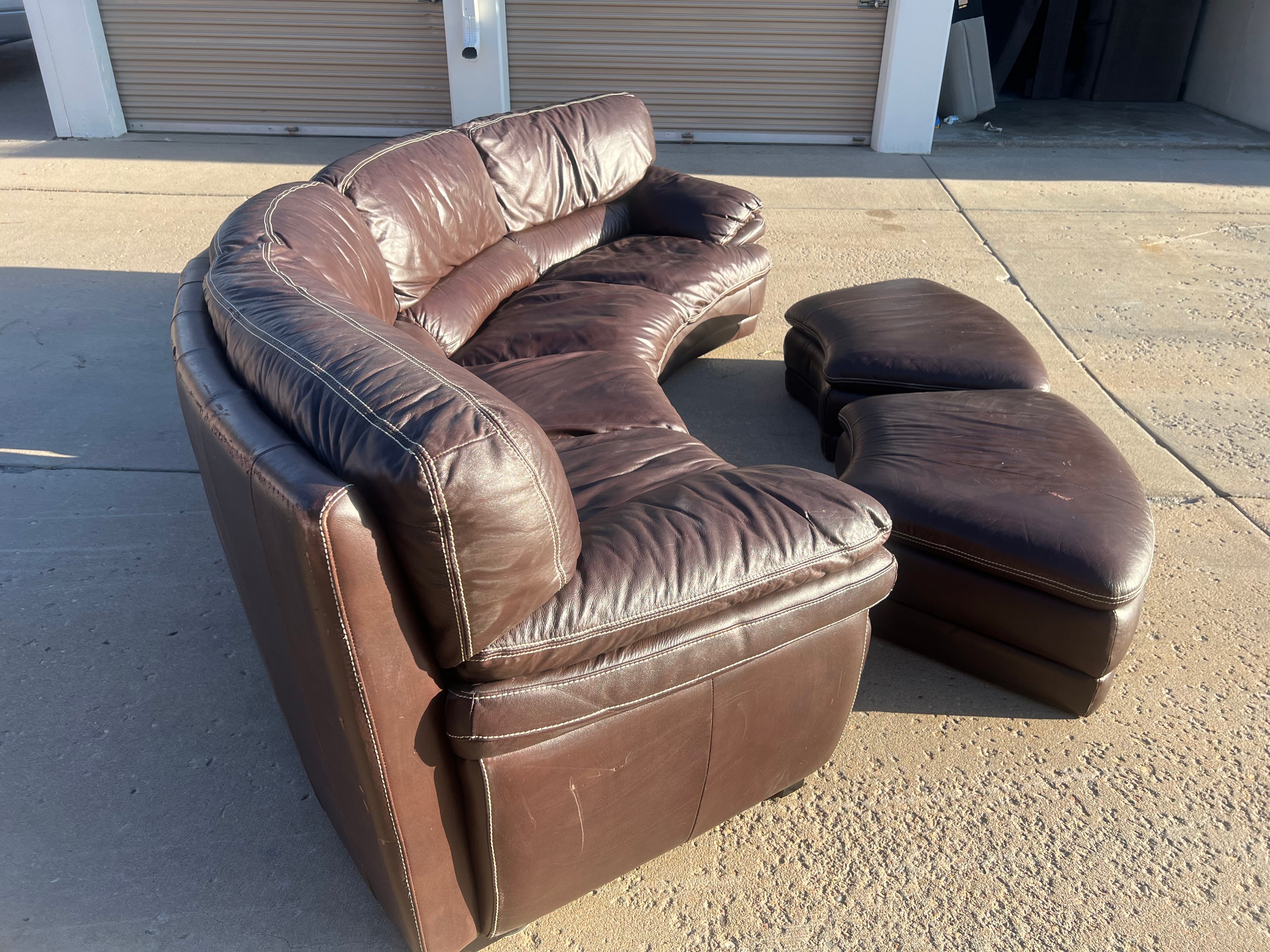 Curved Leather Sectional with 2 Storage Ottomans